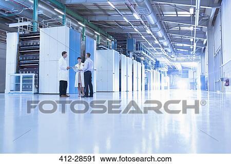 Scientists and businessman talking in factory View Large Photo Image Stock Image - Scientists and businessman talking in factory. Fotosearch