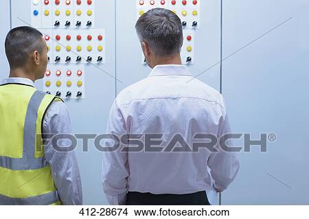 Supervisor and worker at control panel in factory View Large Photo Image Picture - Supervisor and worker at control panel in factory. Fotosearch