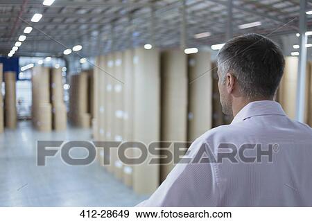 Supervisor looking out over warehouse View Large Photo Image Stock Photo - Supervisor looking out over warehouse. Fotosearch