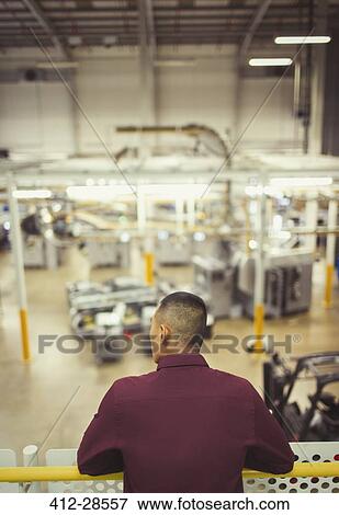 Supervisor on platform looking out over factory View Large Photo Image Stock Photo - Supervisor on platform looking out over factory. Fotosearch