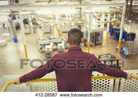 Supervisor on platform looking out over factory View Large Photo Image Stock Photo - Supervisor on platform looking out over factory. Fotosearch