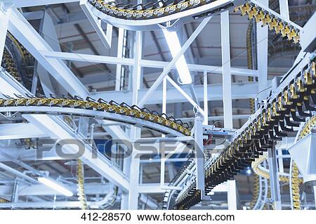 Stock Image - Winding printing press conveyor belts overhead. Fotosearch