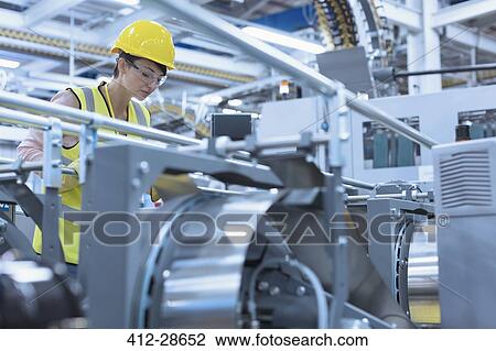 Worker at machinery in factory View Large Photo Image Stock Image - Worker at machinery in factory. Fotosearch