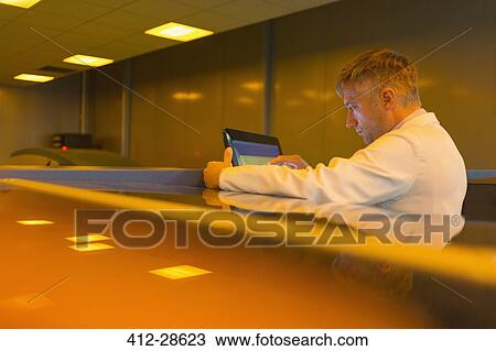 Worker at touch screen in factory View Large Photo Image Stock Image - Worker at touch screen in factory. Fotosearch
