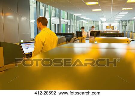 Workers at computers among printers in printing plant View Large Photo Image Stock Image - Workers at computers among printers in printing plant. Fotosearch