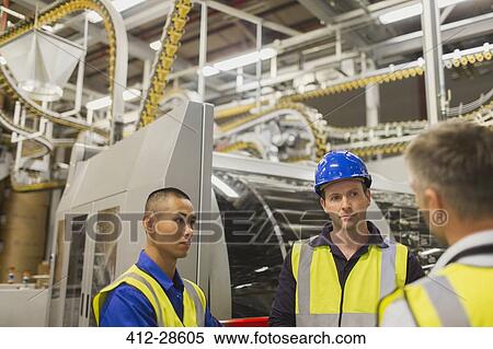 Workers talking in printing plant View Large Photo Image Stock Photography - Workers talking in printing plant. Fotosearch