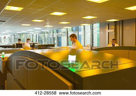 Stock Photo - Workers using printers in printing plant. Fotosearch