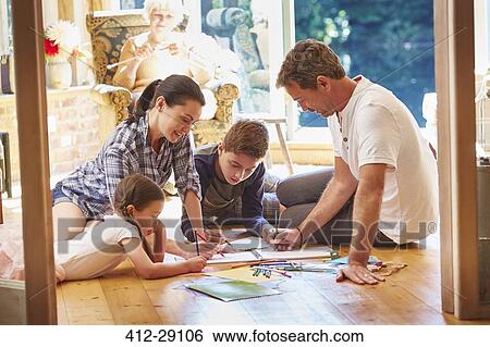 Family drawing and coloring on floor in living room View Large Photo Image Stock Photograph - Family drawing and coloring on floor in living room. Fotosearch