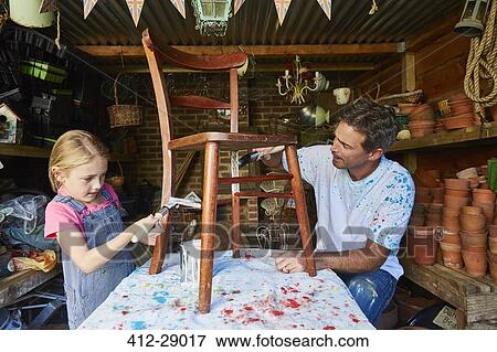 Father and daughter painting chair in workshop View Large Photo Image Stock Photo - Father and daughter painting chair in workshop. Fotosearch