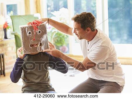 Father placing robot mask on son View Large Photo Image Stock Image - Father placing robot mask on son. Fotosearch