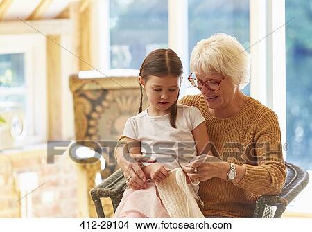 Picture - Grandmother teaching granddaughter knitting. Fotosearch