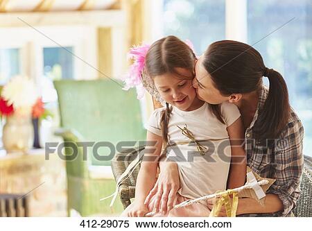 Mother kissing daughter’s cheek View Large Photo Image Stock Photography - Mother kissing daughter’s cheek. Fotosearch