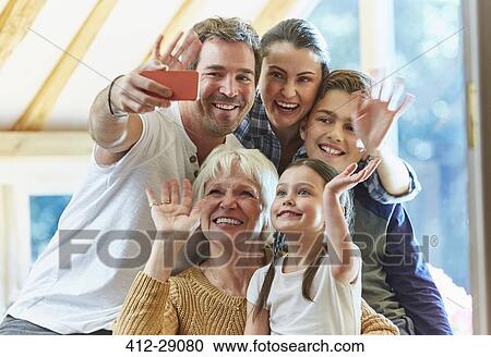 Multi-generation family waving and taking selfie View Large Photo Image Stock Image - Multi-generation family waving and taking selfie. Fotosearch