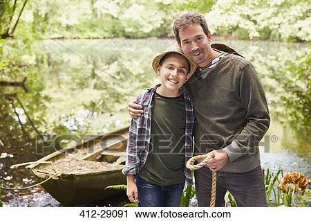Portrait father and son with boat at pond View Large Photo Image Stock Image - Portrait father and son with boat at pond. Fotosearch