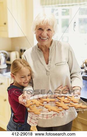 Portrait smiling grandmother and granddaughter baking gingerbread cookies View Large Photo Image Stock Photo - Portrait smiling grandmother and granddaughter baking gingerbread cookies. Fotosearch