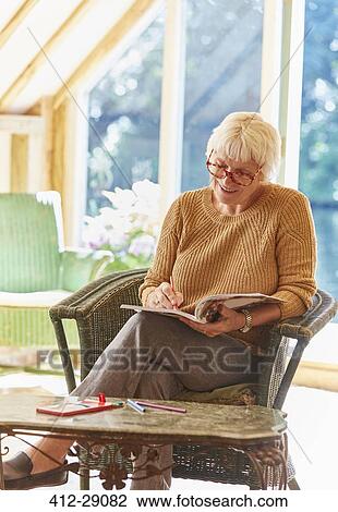Senior woman coloring in coloring book View Large Photo Image Stock Image - Senior woman coloring in coloring book. Fotosearch