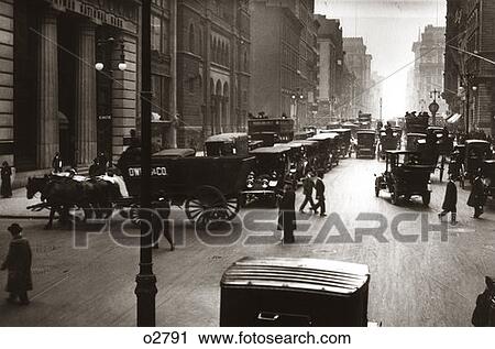 Stock Image - 1890 1890S 1900 1900S Turn Of Century New York City Street Scene Pedestrians Horse & Wagons Automobiles Cars Traffic Manhattan. Fotosearch