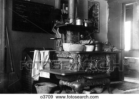1890S 1900S Turn Of Century Cast Iron Stove With Pots And Pans In Kitchen Towels Hanging View Large Photo Image Stock Photo - 1890S 1900S Turn Of Century Cast Iron Stove With Pots And Pans In Kitchen Towels Hanging. Fotosearch