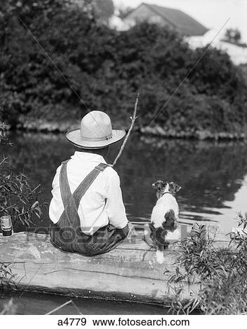 1920S 1930S Farm Boy Wearing Straw Hat And Overalls Sitting On Log With Spotted Dog Fishing In Pond View Large Photo Image Stock Photo - 1920S 1930S Farm Boy Wearing Straw Hat And Overalls Sitting On Log With Spotted Dog Fishing In Pond . Fotosearch