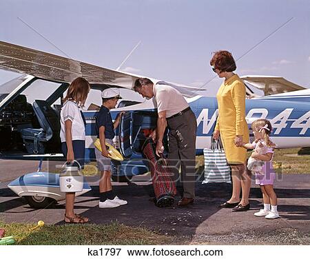1960 1960S Retro Family Loading Luggage Onto Private Prop Airplane Plane Travel Vacation Mother Father Children View Large Photo Image Stock Photo - 1960 1960S Retro Family Loading Luggage Onto Private Prop Airplane Plane Travel Vacation Mother Father Children . Fotosearch