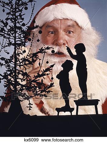 1960S Silhouettes Of Boy And Girl Looking Up At Christmas Tree Santa Claus In Background View Large Photo Image Stock Photo - 1960S Silhouettes Of Boy And Girl Looking Up At Christmas Tree Santa Claus In Background. Fotosearch