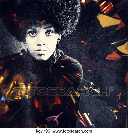 1970 1970S African-American Woman Large Afro Hair Style Hairstyle Special Effect Lighting Hoop Earings Fashion Portrait View Large Photo Image Stock Photograph - 1970 1970S African-American Woman Large Afro Hair Style Hairstyle Special Effect Lighting Hoop Earings Fashion Portrait . Fotosearch