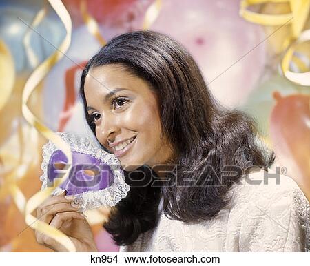 1970 1970S African-American Young Woman Holding Purple Eye Mask Background Balloons Streamers Celebration Retro View Large Photo Image Picture - 1970 1970S African-American Young Woman Holding Purple Eye Mask Background Balloons Streamers Celebration Retro. Fotosearch
