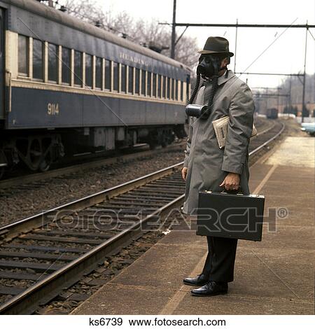 1970 1970S Businessman Man Briefcase Train Station Railroad Platform Wearing Gas Mask Environment Smog Rrr Retro View Large Photo Image Stock Photo - 1970 1970S Businessman Man Briefcase Train Station Railroad Platform Wearing Gas Mask Environment Smog Rrr Retro . Fotosearch