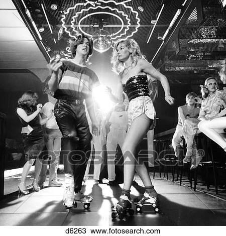 1970 1970S Couple Disco Dancing On Roller Skates Wearing Trendy Clothes