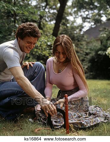 1970 1970S Couple Man Woman Outdoors Yard Lawn Summer Playing Horseshoes Game Activity Retro View Large Photo Image Picture - 1970 1970S Couple Man Woman Outdoors Yard Lawn Summer Playing Horseshoes Game Activity Retro. Fotosearch