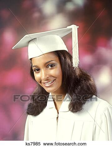 1970 1970S Ethnic African-American Woman Girl Teen Smile Smiling Wear White Robe Mortar Board Graduate Graduation View Large Photo Image Stock Photography - 1970 1970S Ethnic African-American Woman Girl Teen Smile Smiling Wear White Robe Mortar Board Graduate Graduation . Fotosearch