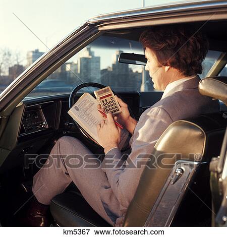 1970 1970S Man Businessman Salesman Sitting Drivers Seat Car Door Open Hold Papers Calculator Business Cars View Large Photo Image Stock Photo - 1970 1970S Man Businessman Salesman Sitting Drivers Seat Car Door Open Hold Papers Calculator Business Cars . Fotosearch