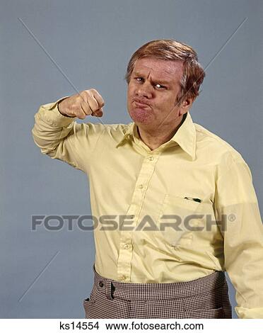 Picture - 1970 1970S Man Raising Fist Angry Threatening Scowl Retro. Fotosearch
