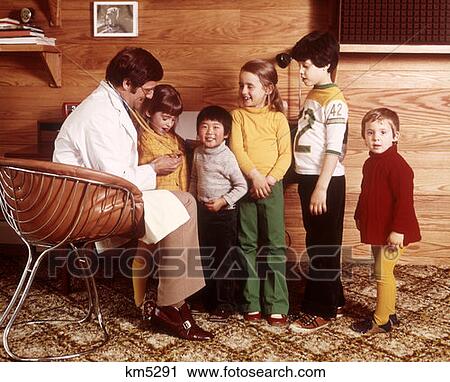 1970 1970S Man White Coat Stehoscope Doctor 5 Children Boys Girls Ethnically Diverse Asian School Doctors Office  View Large Photo Image Stock Image - 1970 1970S Man White Coat Stehoscope Doctor 5 Children Boys Girls Ethnically Diverse Asian School Doctors Office . Fotosearch