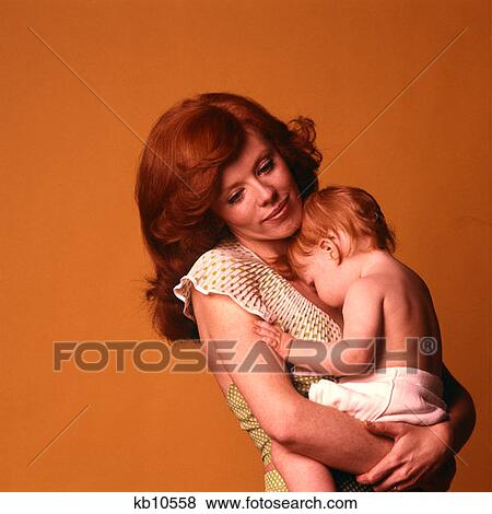 1970 1970S Mother Child Baby Both Red Hair Auburn Redheads Caring Loving Pose Holding Baby Closse Family Families View Large Photo Image Stock Photo - 1970 1970S Mother Child Baby Both Red Hair Auburn Redheads Caring Loving Pose Holding Baby Closse Family Families . Fotosearch