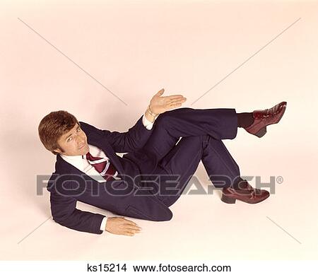 1970 1970S Overhead Looking Down Man Lying Down Legs Crossed Wear Business Suit Shrug Off Hand Expression Gesture View Large Photo Image Picture - 1970 1970S Overhead Looking Down Man Lying Down Legs Crossed Wear Business Suit Shrug Off Hand Expression Gesture . Fotosearch