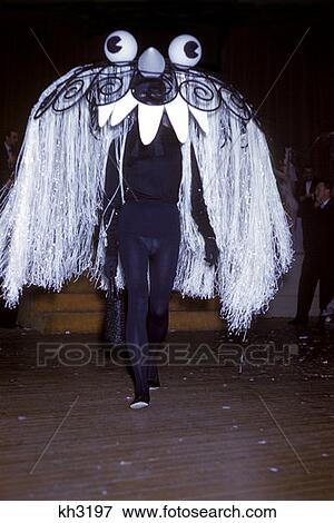 1970 1970S Person Black Leotard Wearing Headdress Large Eyes Insect Costume Parade Trick Treat Costumes Retro View Large Photo Image Stock Photo - 1970 1970S Person Black Leotard Wearing Headdress Large Eyes Insect Costume Parade Trick Treat Costumes Retro . Fotosearch