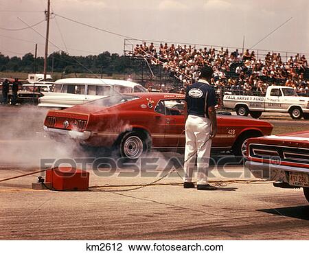 1970 1970S Pit Mechanic By Race Car Burning Rubber Drag Racing Brownsville Indiana Speed Mechanic Cars View Large Photo Image Stock Image - 1970 1970S Pit Mechanic By Race Car Burning Rubber Drag Racing Brownsville Indiana Speed Mechanic Cars . Fotosearch