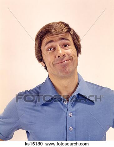 1970 1970S Portrait Man Head Shoulders Funny Silly Smiling Expression Blue Shirt Smirk Face Grin Grinning Smile View Large Photo Image Stock Image - 1970 1970S Portrait Man Head Shoulders Funny Silly Smiling Expression Blue Shirt Smirk Face Grin Grinning Smile . Fotosearch