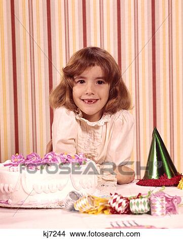 1970 1970S Portrait Smiling Girl Missing Front Teeth Birthday Cake Party Favors Happy Celebration Celebrate Parties View Large Photo Image Picture - 1970 1970S Portrait Smiling Girl Missing Front Teeth Birthday Cake Party Favors Happy Celebration Celebrate Parties . Fotosearch