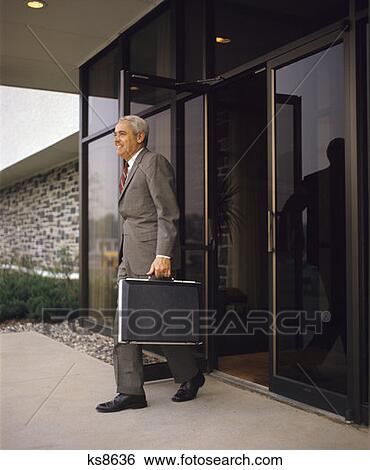 1970 1970S Retro Man Businessman Briefcase Doorway Work Suit Tie Walking View Large Photo Image Stock Photograph - 1970 1970S Retro Man Businessman Briefcase Doorway Work Suit Tie Walking. Fotosearch