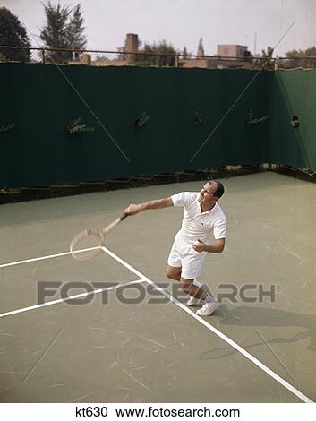 1970 1970S Retro Man Playing Tennis Swinging Racket To Hit Ball Action Recreation Exercise View Large Photo Image Stock Image - 1970 1970S Retro Man Playing Tennis Swinging Racket To Hit Ball Action Recreation Exercise . Fotosearch