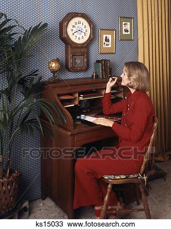 1970 1970S Retro Woman Sitting Desk Writing Clock Plant View Large Photo Image Stock Image - 1970 1970S Retro Woman Sitting Desk Writing Clock Plant. Fotosearch