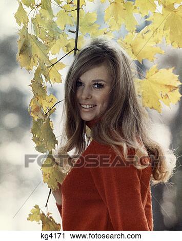 Stock Image - 1970 1970S Retro Woman Smile Leaves Tree Autumn Portrait. Fotosearch