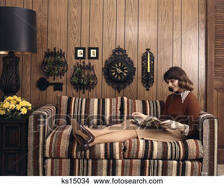 Picture - 1970 1970S Retro Woman Sofa Couch Wood Paneling Clock Lamp Reading . Fotosearch