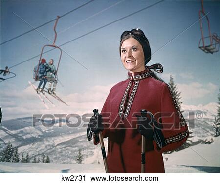 1970 1970S Retro Woman Winter Gear Goggles Holding Ski Poles Lift Snow Mountains Background View Large Photo Image Stock Image - 1970 1970S Retro Woman Winter Gear Goggles Holding Ski Poles Lift Snow Mountains Background. Fotosearch