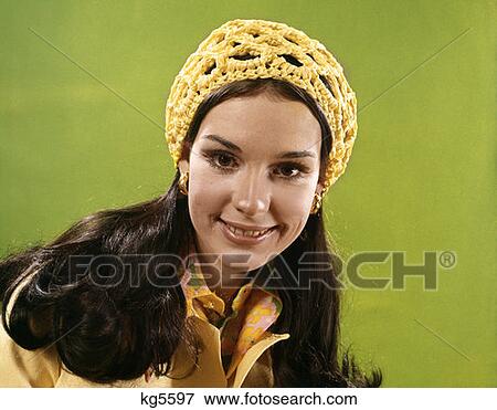 Stock Photo - 1970 1970S Smiling Brunette Woman Wear Yellow Yarn Crocheted Crochet Hat Cap . Fotosearch