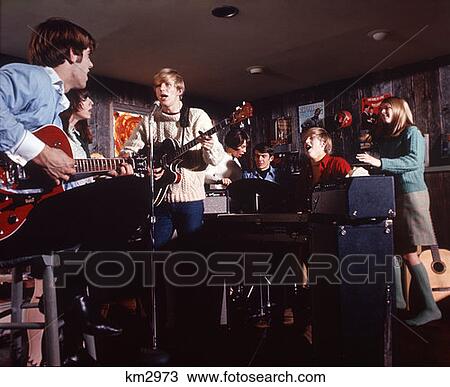 1970 1970S Teen Teenage Rock Band Teenagers Boys Girls Singing Microphones Amplifiers Guitars View Large Photo Image Stock Image - 1970 1970S Teen Teenage Rock Band Teenagers Boys Girls Singing Microphones Amplifiers Guitars . Fotosearch