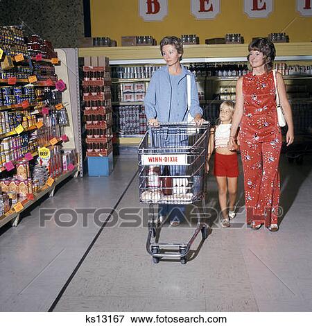 1970 1970S Two Women Small Girl Walking Down Supermarket Grocery Store Aisle Woman Pushing Cart Kart Groceries Stores View Large Photo Image Stock Photo - 1970 1970S Two Women Small Girl Walking Down Supermarket Grocery Store Aisle Woman Pushing Cart Kart Groceries Stores . Fotosearch