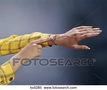 1970 1970S Woman Hands Finger Pointing To Wrist Watch Yellow & Black Checked Sleeves Watches Time Jewelry Retro View Large Photo Image Stock Photography - 1970 1970S Woman Hands Finger Pointing To Wrist Watch Yellow & Black Checked Sleeves Watches Time Jewelry Retro. Fotosearch